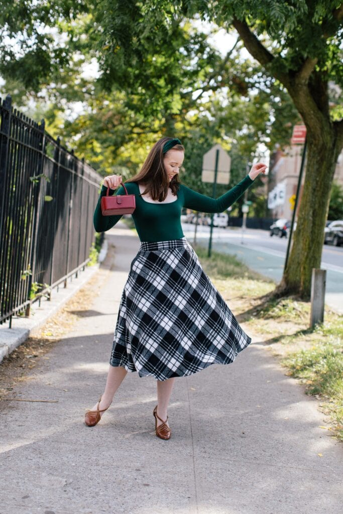 Woman in green and plaid 1940s inspired clothing